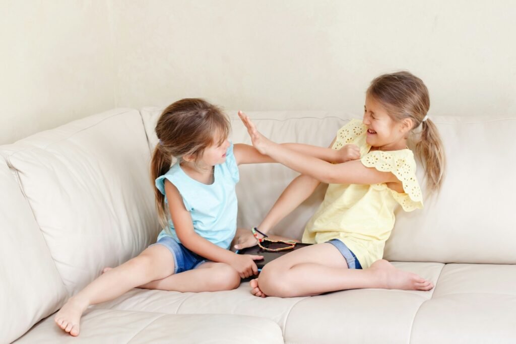 Two girls fighting playfully.