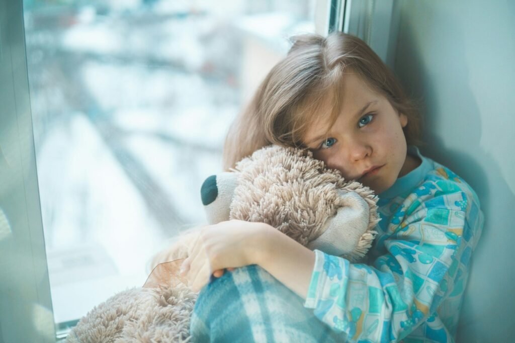 A sick child with a teddy.
