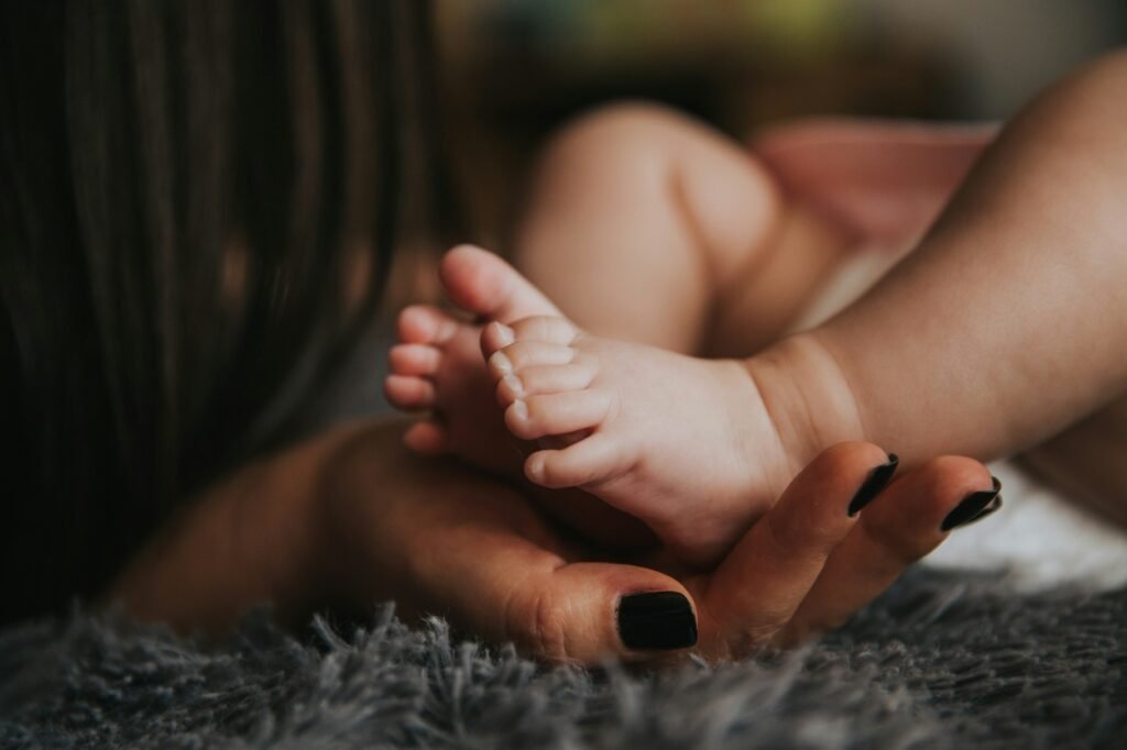 Baby's feet in mother's hand.