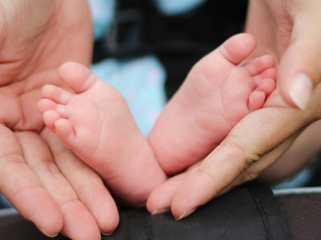 Little baby's feet in mother's hand.