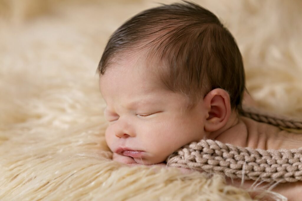Cute baby inside beige and brown cloth.