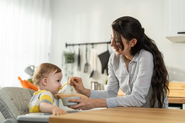 Beautiful mother taking care of toddler in the kitchen area.