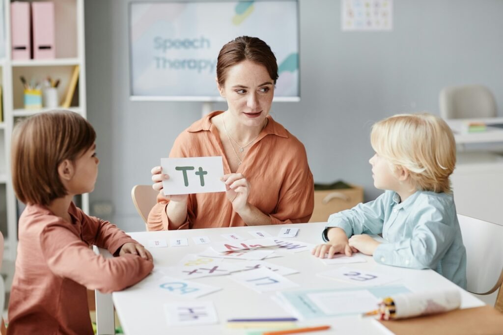 A teacher is teaching alphabet.