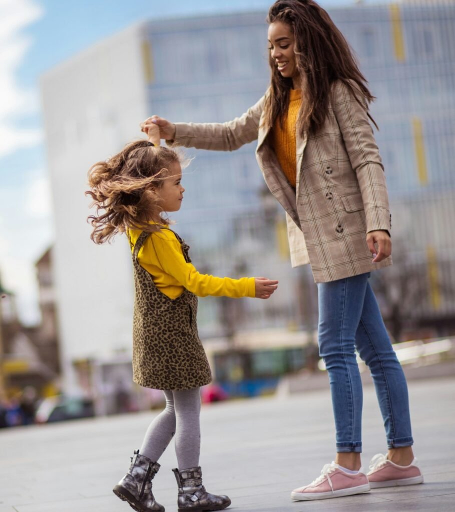 Beautiful mother dancing with her daughter.