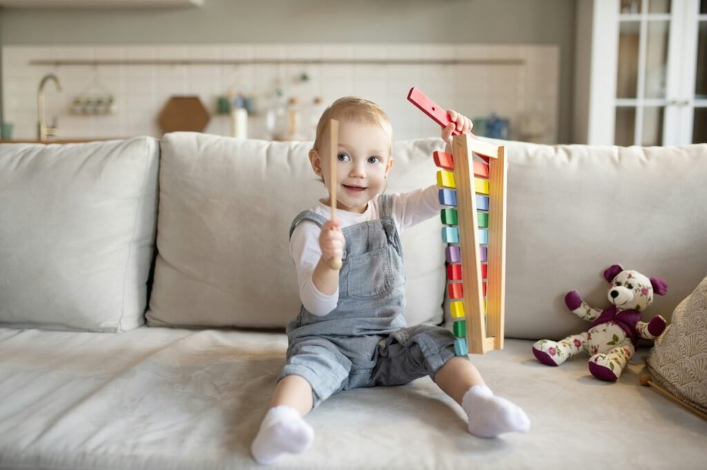 Little baby is playing with xylophone.