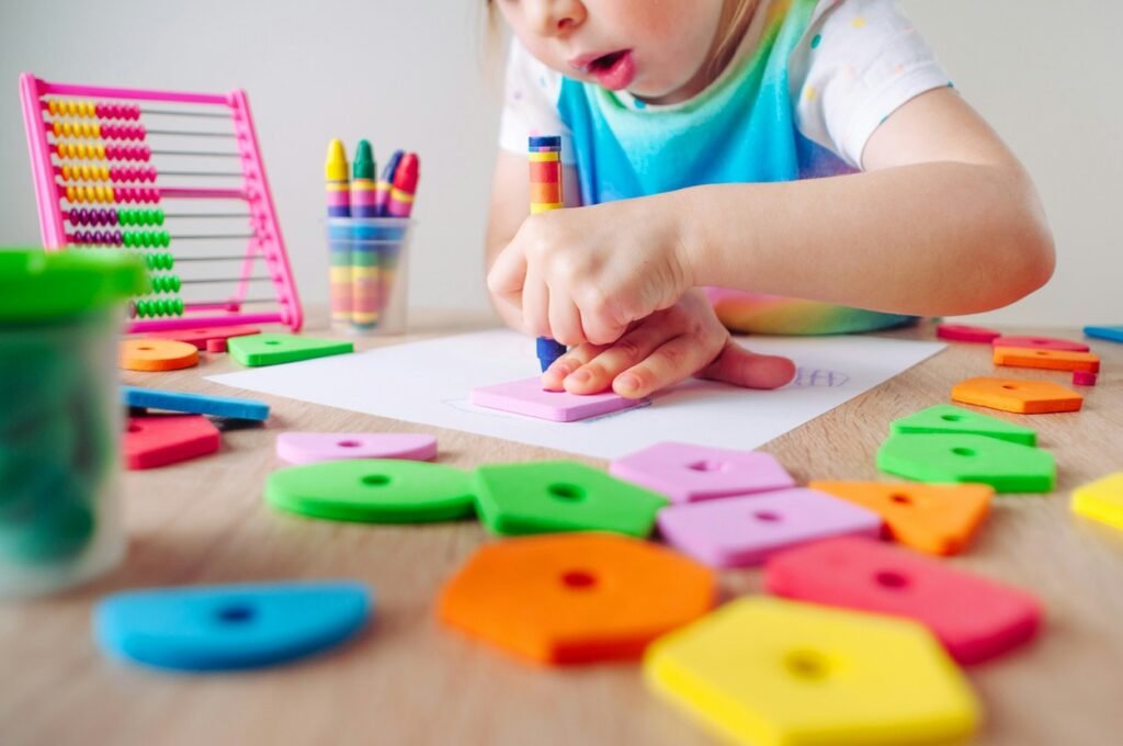 Little girl is drawing with colors.