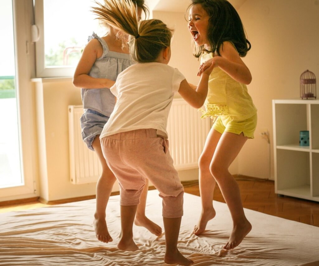 Three little girls jumping.