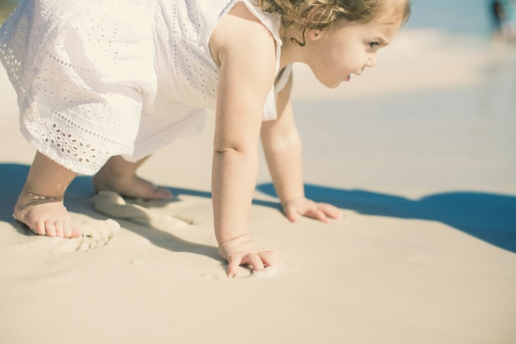 Toddler playing at sea beach.