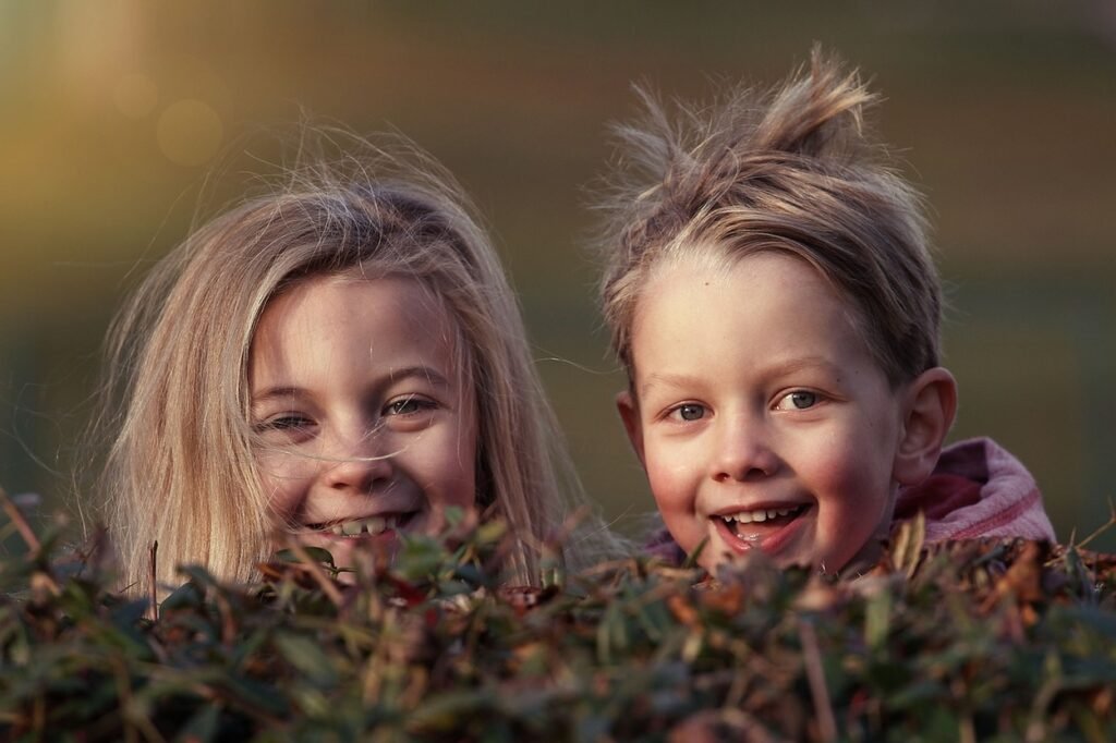 Two little kids smiling.