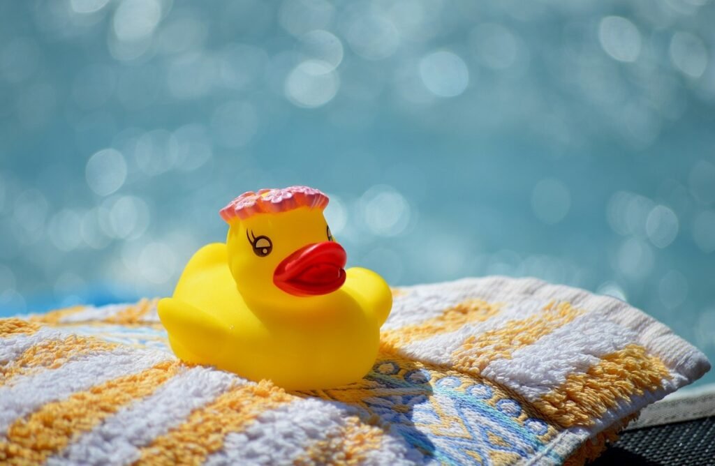 Yellow duck on top of a towel.