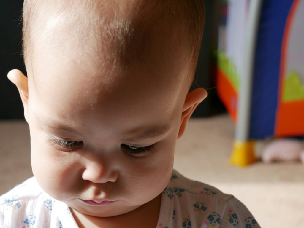 A little baby with head down.